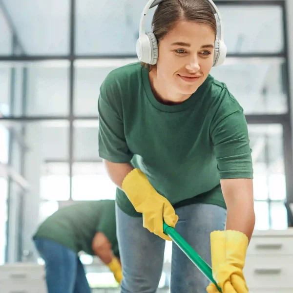 shot-of-a-young-woman-cleaning-an-office-with-her-2026-01-09-11-30-34-utc