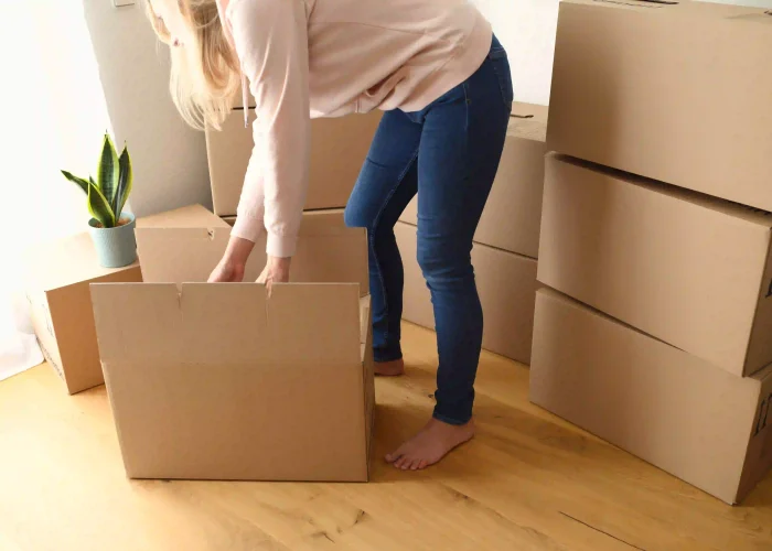 young-happy-woman-unpacking-or-packing-carton-boxe-2026-01-06-09-40-50-utc
